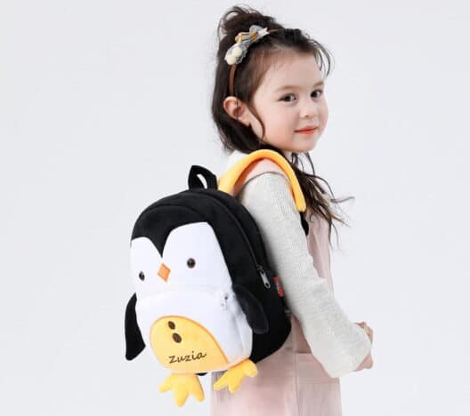 Dziewczynka z dziecięcym plecakiem w kształcie Pingwina